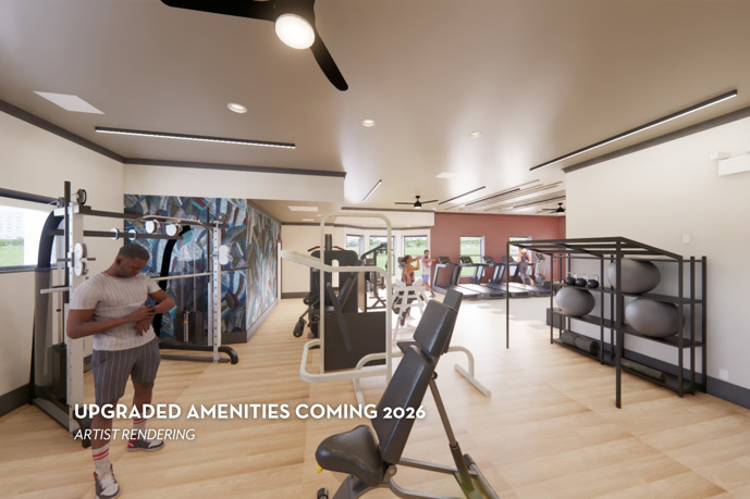 A fitness center equipped with exercise equipment, a spacious wall mirror, and ceiling fans to keep you cool during your workouts at Waterstone at Big Creek in Alpharetta, GA.